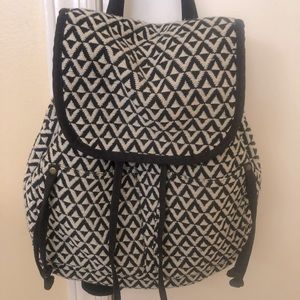 Medium sized cream and black cloth backpack.